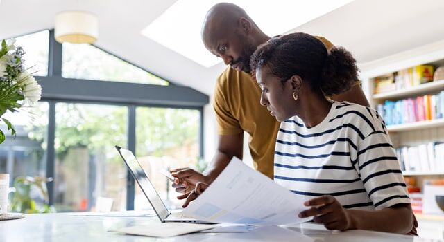 Young couple learning about how much is car insurance in NY