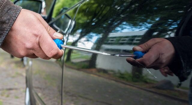 Person committing vandalism on a car